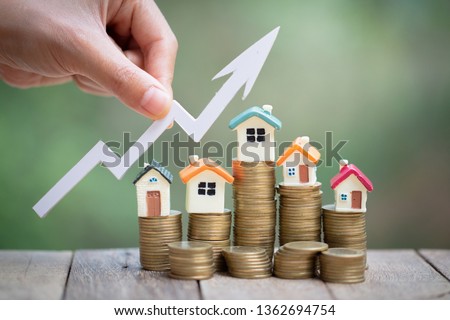 Mini model house on coins stack, growing business, Property investment and house mortgage financial concept Royalty-Free Stock Photo #1362694754