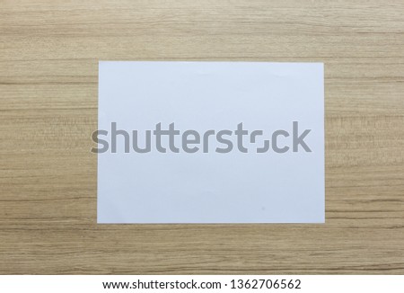 Paper on wooden desk.