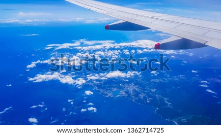 Looking at the window of the plane in Asia