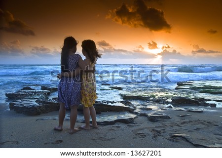 two girls in the beach at sunset