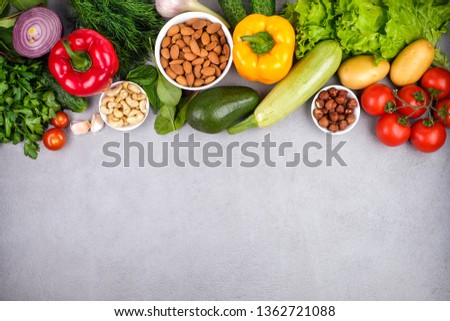 Kitchen - fresh colorful organic vegetables captured from above top view, flat lay. Grey stone worktop as background. Layout with free text.