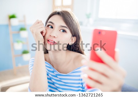 beautiful woman taking selfie from hand with phone