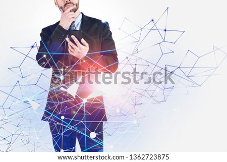 Unrecognizable pensive man with smartphone standing over white background with network hologram. Concept of telecommunication in business and social media. Toned image double exposure