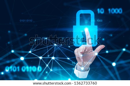 Hand of young businesswoman using online security interface over dark blue background. Concept of hi tech. Toned image double exposure