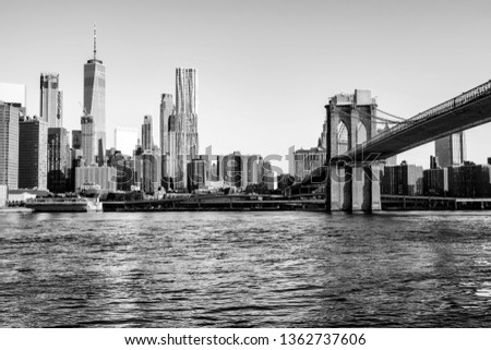 New York, USA. View of Manhattan bridge and Manhattan in New York, USA in the morning. Clear sky with skyscrapers. Black and white