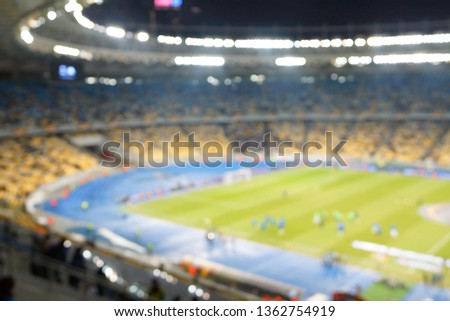 blur image of soccer stadium in twilight time for abstract background usage.