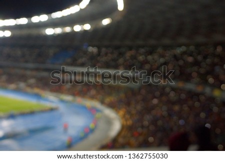 blur image of soccer stadium in twilight time for abstract background usage.