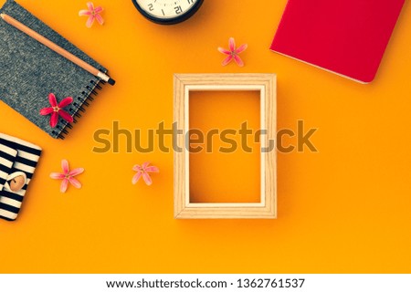 space orange vintage notebook with clock and picture frame
