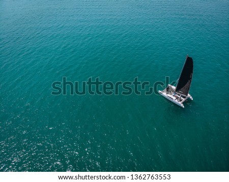 aerial View Of   little yacht with black sail  At The Andaman sea. Phuket. Thailand 