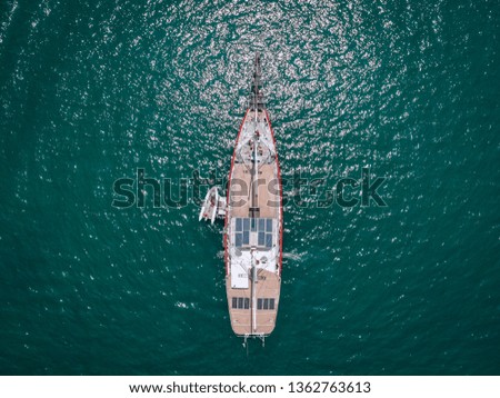 Aerial drone top view photo of luxury yacht with white rubber boat. Phuket. Thailand.