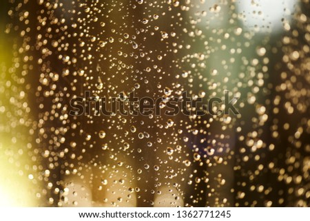 Texture of water drops left by the rain over the window