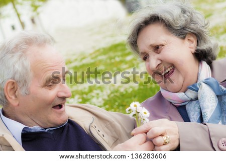 A couple of older people with a big smile is proof that love can last for a long time.