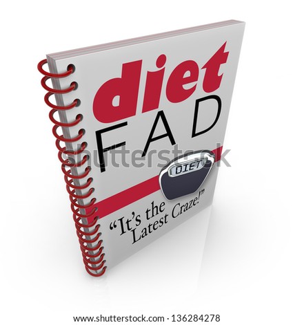 A spiral-bound book with the words Diet Fad - It's the Latest Craze to illustrate a new dieting sensation inside a best-selling manual or guide to help you lose weight