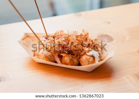 ready to eat takoyaki on the wooden table in the street food cafe  Royalty-Free Stock Photo #1362867023