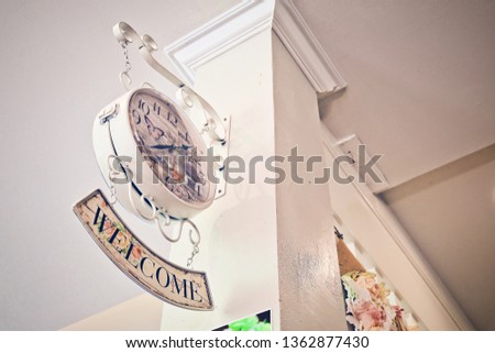 Vintage wall clock and Welcome label   on the restaurant