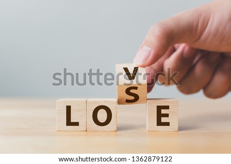 Hand flip wooden cube block with word LOVE change to LOSE. Concept of losing love Royalty-Free Stock Photo #1362879122