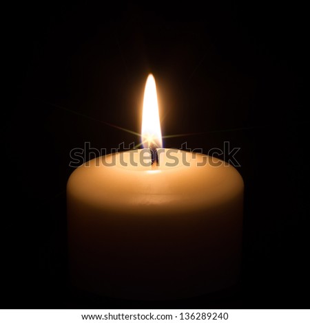 Candle on black background with star effect