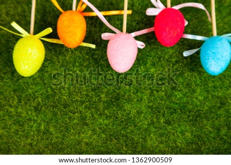 Easter eggs on green grass. Easter still life.Border of colorful Easter eggs.