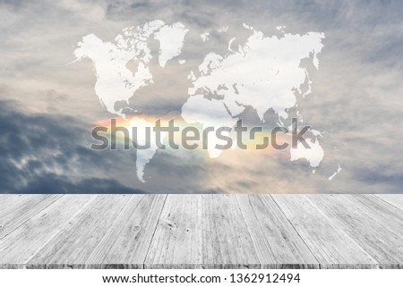 Cloudscape of natural sky with blue sky and white clouds with irisation or iridescence in the sky use for wallpaper background with wood table or terrace and world map