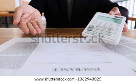 Vehicle and Transportation concept, Insurance agent consultant and calculator with policy contract on clipboard.
