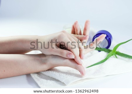 beautiful hands of a girl cream green aloe white background