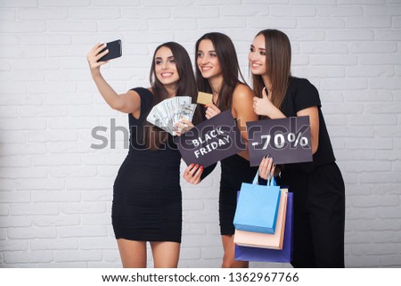 Shopping. Elegant brunette womans wears black dress holding shopping bags, black friday concept