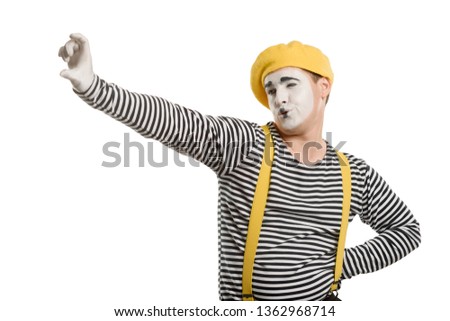 Mime actor taking a selfie with an imaginary mobile phone. Funny pantomime about people and social media.