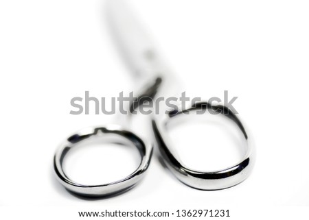 Selected focus handles of a steel clothes cutting scissor on a  isolated white background.