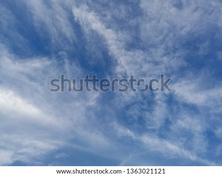 Blue sky with clouds in the blue background.