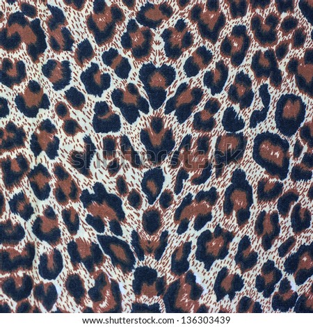 Leopard spots background with fabric texture