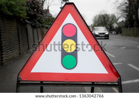 British traffic lights warning sign indicating roadworks and traffic lights ahead