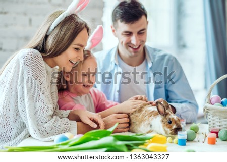 Rabbit is a symbol of Easter.Lovely family preparing for Easter together.In the spotlight home decorative rabbit.