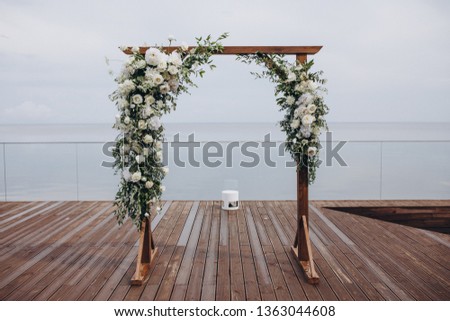 arch for the wedding ceremony stand on the background of water