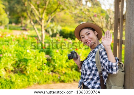 Female tourists who are walking on a photo trip happily.