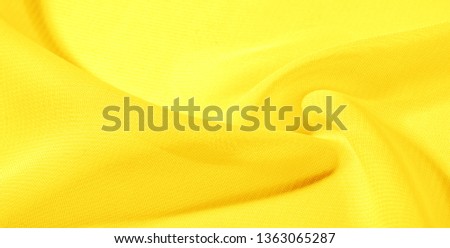 texture background pattern yellow silk fabric. This silk organza has a gentle open weave. Use this luxurious fabric for anything from your design for special occasions to creating your projects.