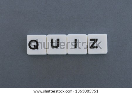 Quiz word made of square letter word on grey background.