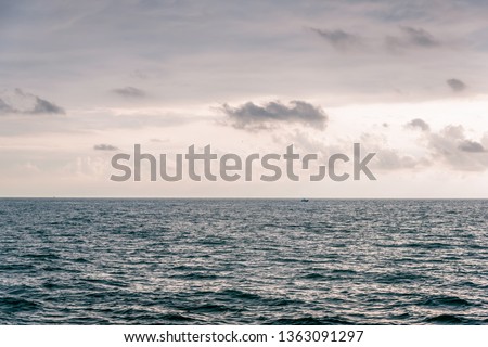 View from cabin balconies at the rough seas and waves off the side of cruise ship. Seascape picture. The sky with clouds, not big waves on the sea surface. Excitement at sea