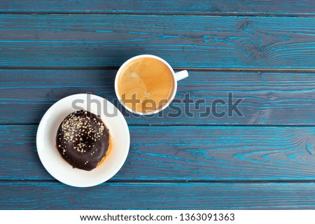 fresh donut with coffee on wooden surface, top view