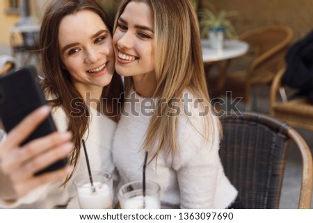 Girlfriends have fun in cafe