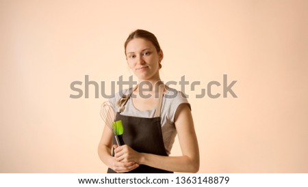 Beautiful happy young woman wearing kitchen apron