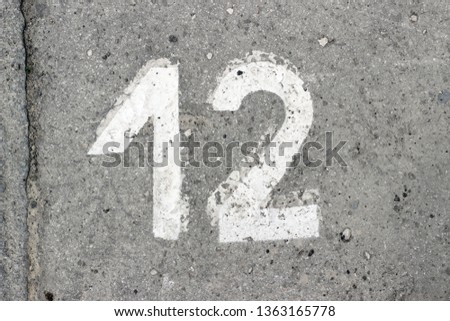 Parking lot asphalt stencil number 12 street sidewalk