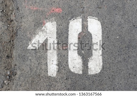 Parking lot asphalt stencil number 10 street sidewalk