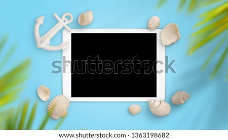 Tablet mockup surrounded with shells and boat anchor. Palm tree above. Blue background. Concept of summer travel app promotion.
