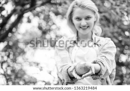 Girl gather apple harvest in own garden. Farmer girl hold apple. Local crops concept. Healthy lifestyle. Eat fruits every day. Woman hold apple green garden background. Organic natural product.