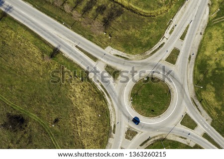 Aerial view of traffic circle roundabout road junction, top view with cars
