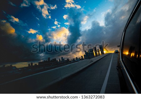 Miami under a cloudy sky at sunset seen from a car on the highway. Southern Florida, USA