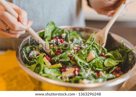 Make an italian salad with green salad, tomato, cheese, pomegranate, walnut, arugula, spinach and olive oil