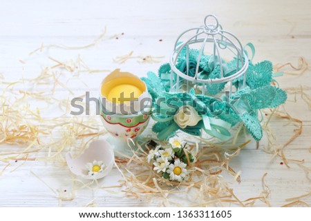 Easter egg in a cocotine against the backdrop of the decoration of the cage
