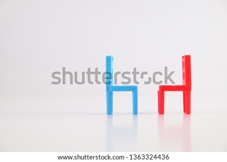 Blue and red chair placed to face each other isolated on white background