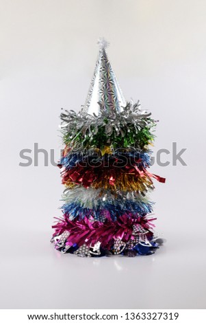 Colorful glittering party hat stacked neatly isolated on white background